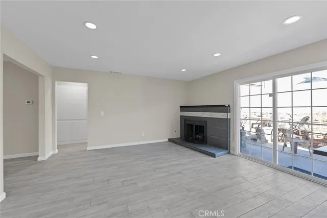 a large kitchen with kitchen island a sink a stove and white cabinets