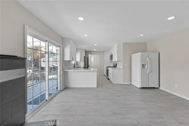 a kitchen with a refrigerator a sink a stove a microwave and island