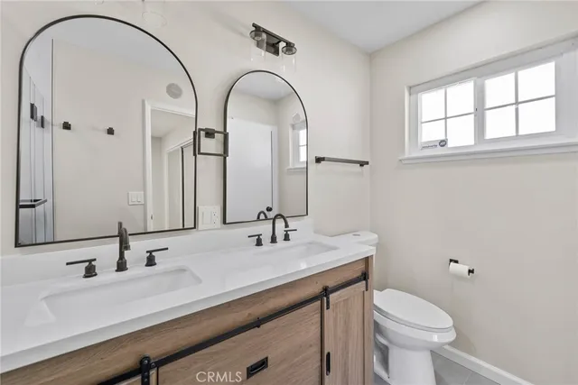 a bathroom with a double vanity sink a mirror and shower