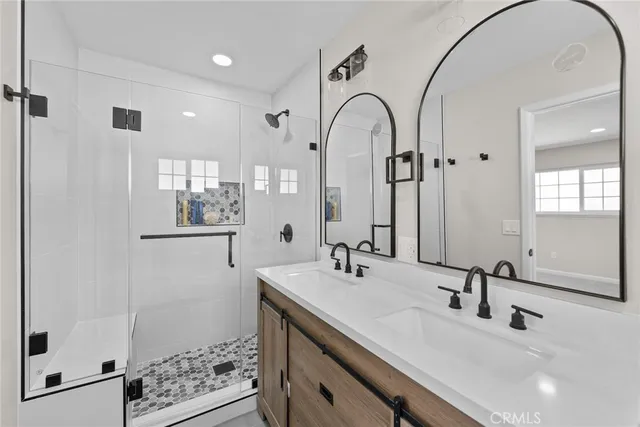 a view of a bathroom with sink mirror and window