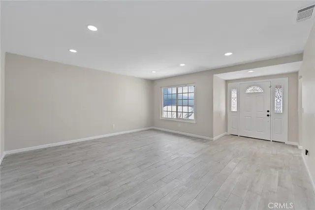 an empty room with windows and closet