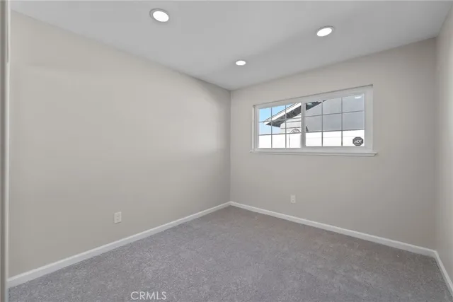 a bathroom with a granite countertop sink a toilet a mirror and shower