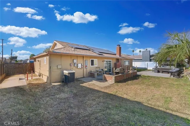 a view of a house with backyard porch and sitting area