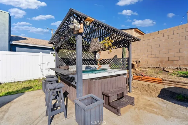 a view of barbeque grill with granite table and chairs