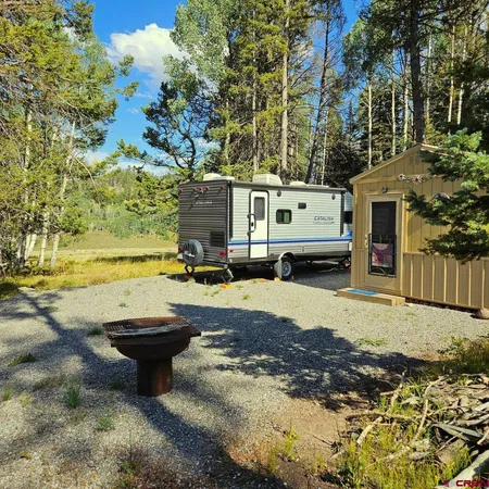 a view of a house with backyard space and sitting area