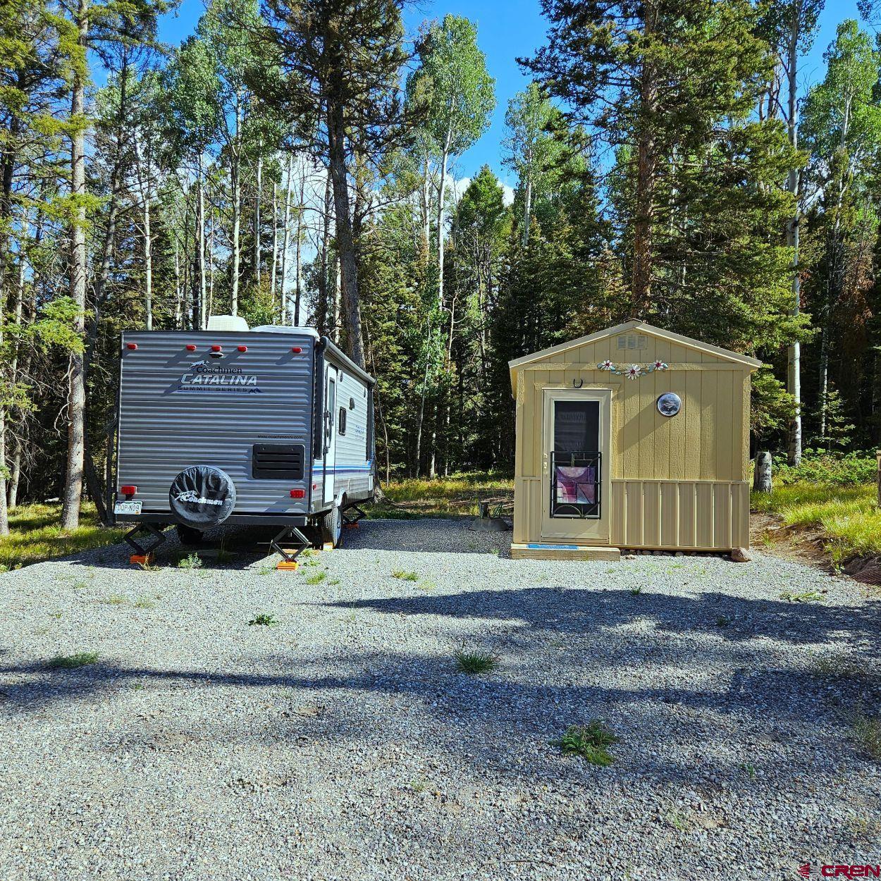 284 Aspen Trail Cimarron, CO 81220 - Photo 7 of 9 a view of a house with a yard and large tree