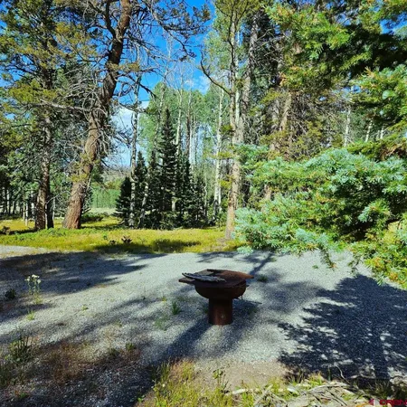 a view of a backyard with swimming pool