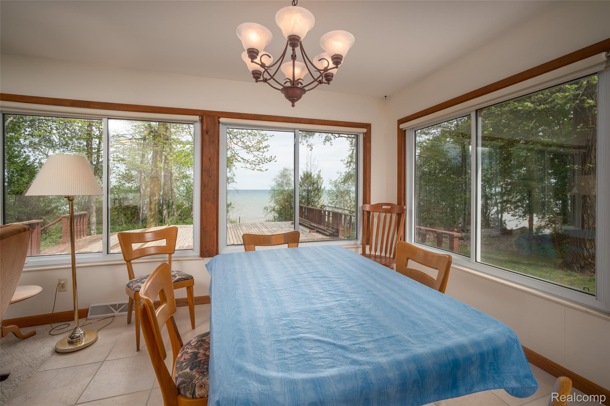 6240 Lakeshore Road Palms, MI 48465 - Photo 13 of 38 Sunroom featuring hanging lights and a water view