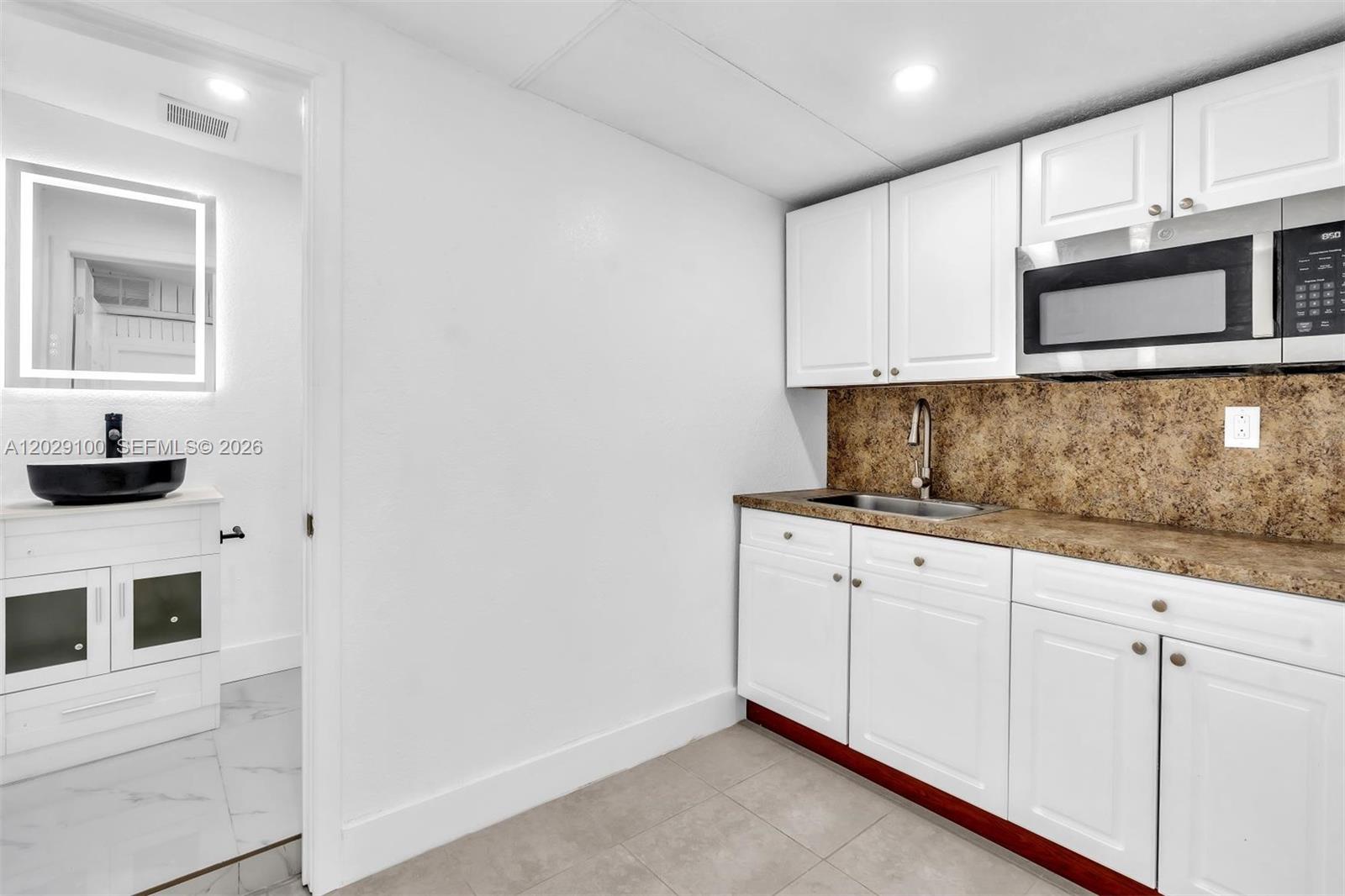 11790 Southwest 34th Street Miami, FL 33175 - Photo 22 of 56 a kitchen with granite countertop white cabinets and white appliances