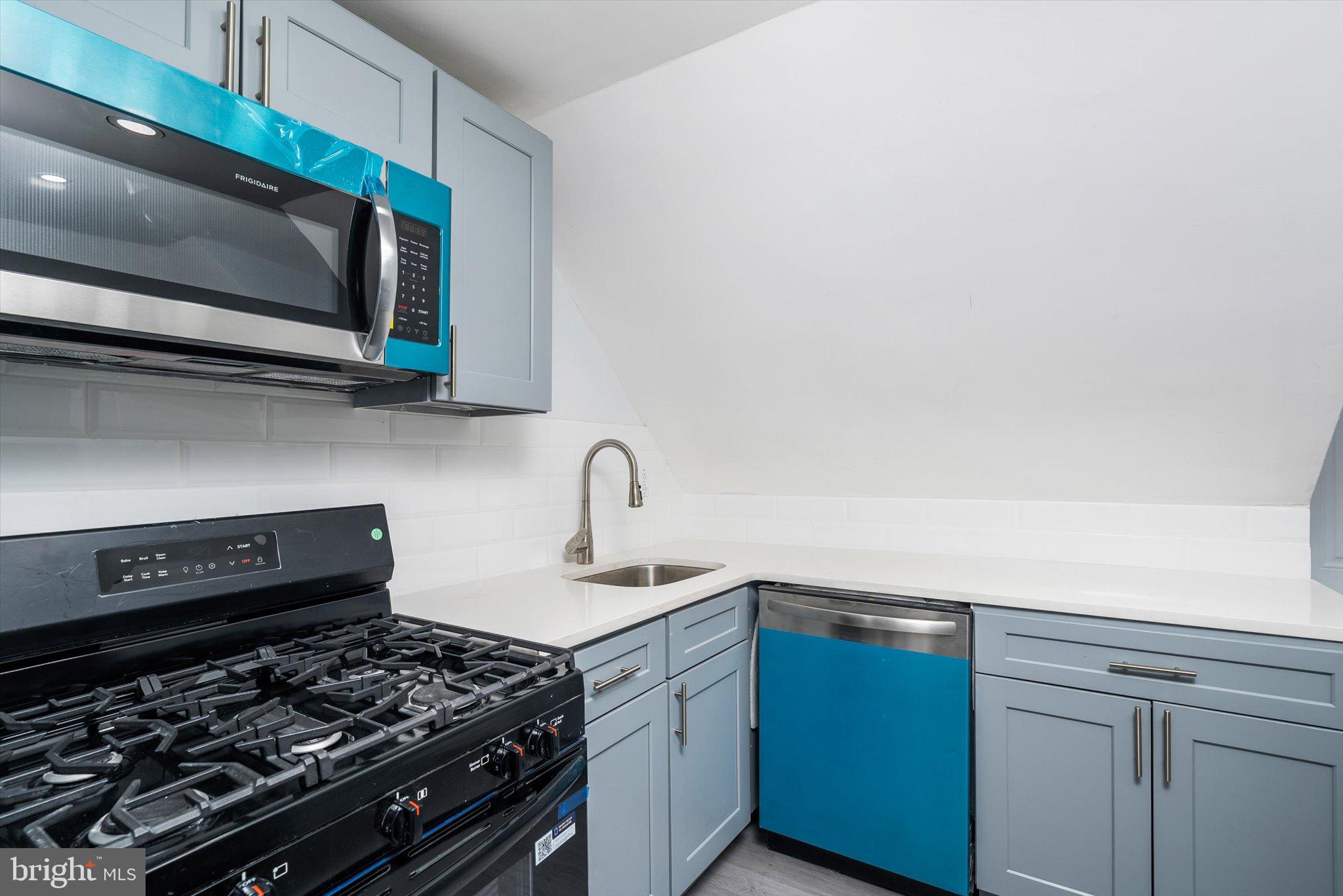 10 Lytle Street, Unit 5 Princeton, NJ 08542 - Photo 10 of 20 a kitchen with stainless steel appliances a stove and a microwave