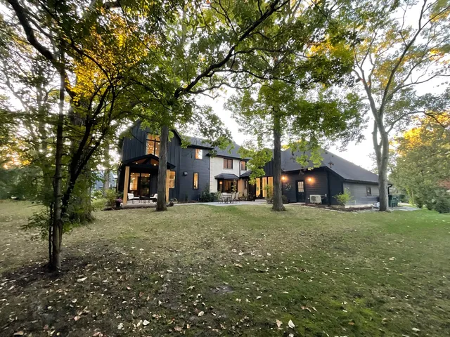 a tree in front of a white house