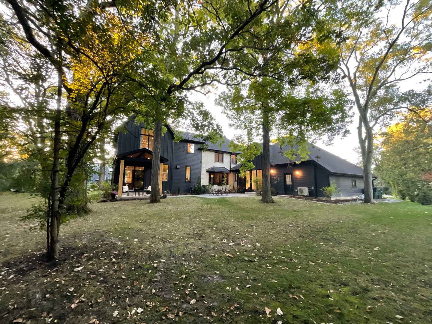 a tree in front of a white house
