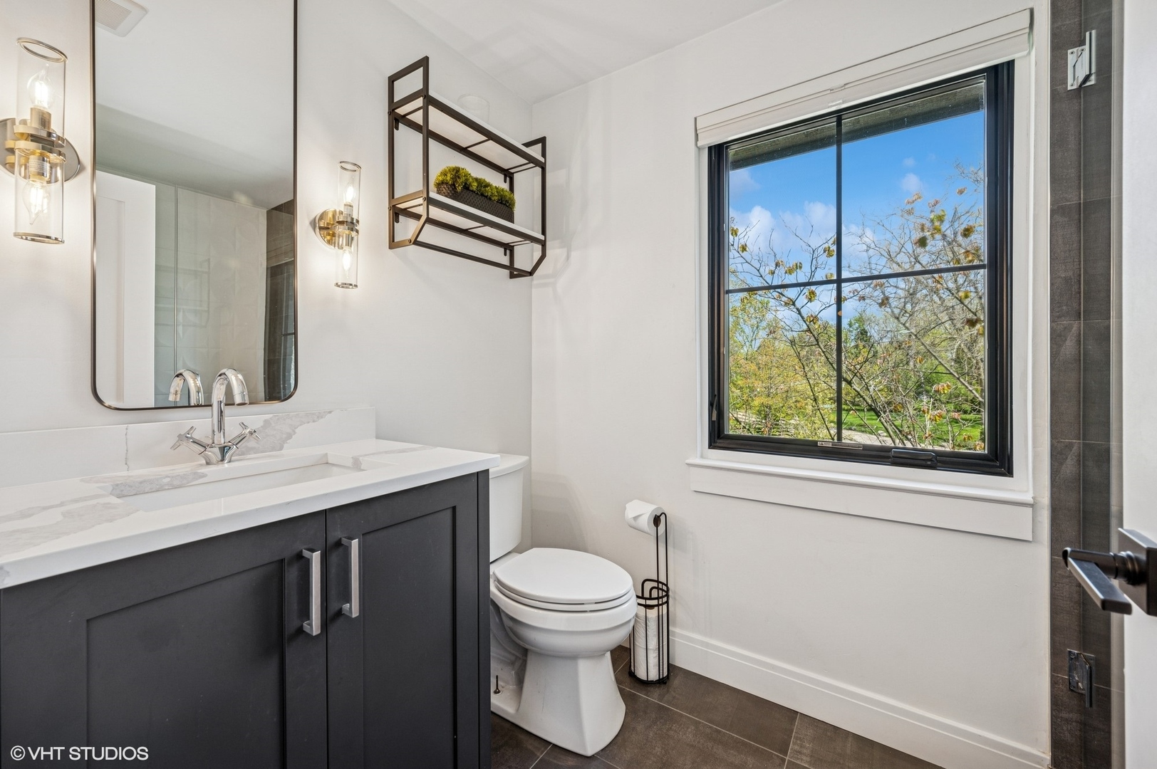 1933 Ridgewood Lane West Glenview, IL 60025 - Photo 24 of 42 a bathroom with a toilet a sink and a mirror