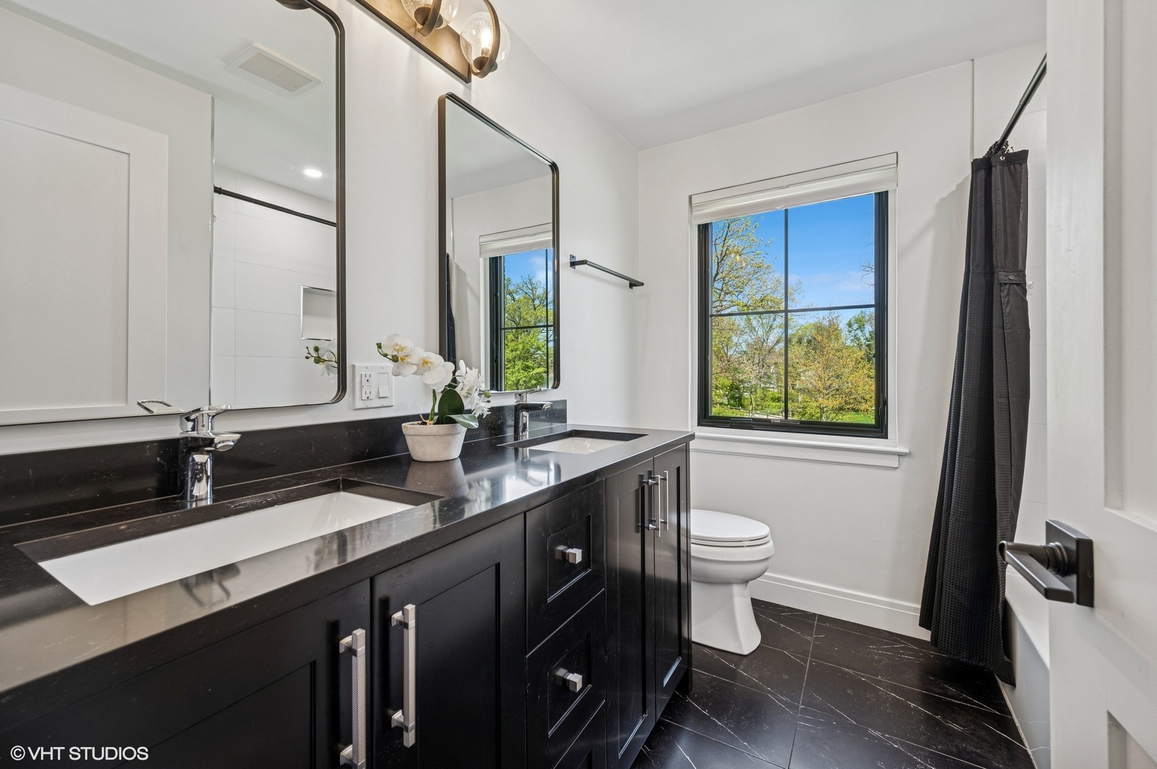 1933 Ridgewood Lane West Glenview, IL 60025 - Photo 26 of 42 a bathroom with a double vanity sink toilet and a mirror