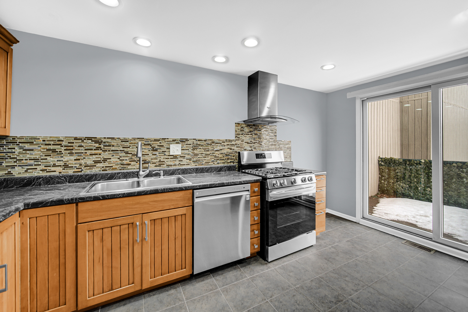 685 High Ridge Road, Unit 5762 Roselle, IL 60172 - Photo 3 of 25 a kitchen with stainless steel appliances granite countertop a stove and a sink