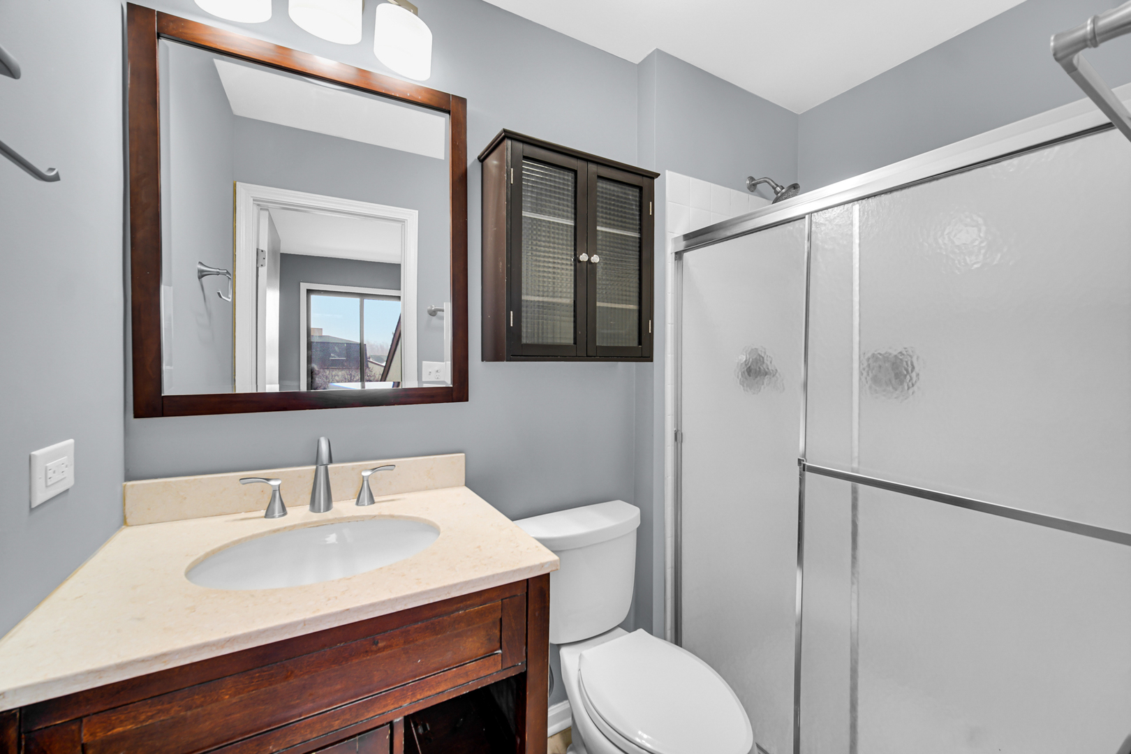 685 High Ridge Road, Unit 5762 Roselle, IL 60172 - Photo 6 of 25 a bathroom with a sink toilet a mirror and shower