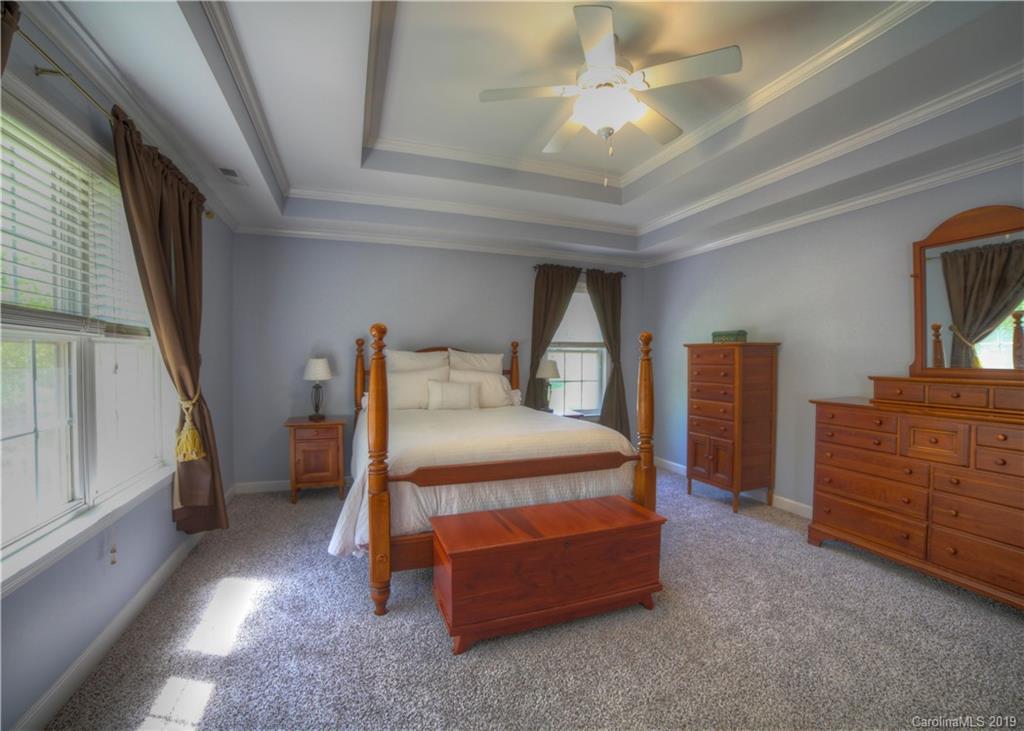 929 Ashford Way, Unit 79 Fort Mill, SC 29708 - Photo 18 of 39 a bedroom with a bed and a cabinets