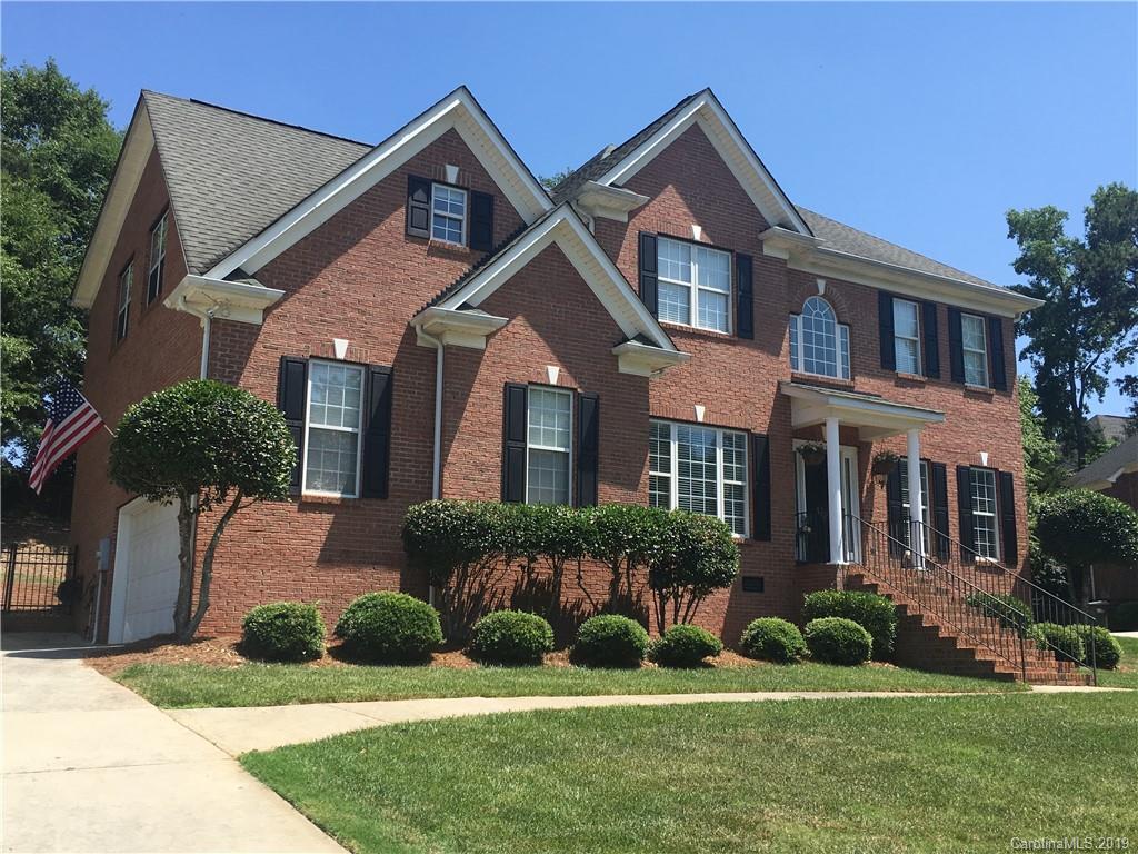 929 Ashford Way, Unit 79 Fort Mill, SC 29708 - Photo 3 of 39 a front view of a house with a yard and plants