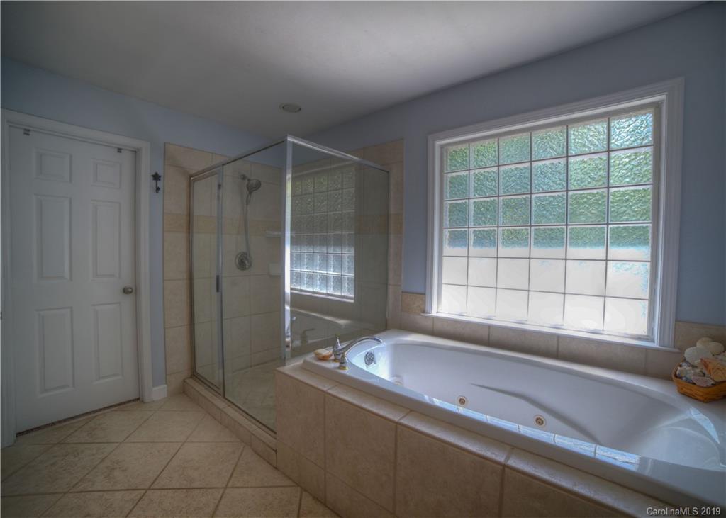 929 Ashford Way, Unit 79 Fort Mill, SC 29708 - Photo 21 of 39 a bath tub sitting in a bathroom next to a window