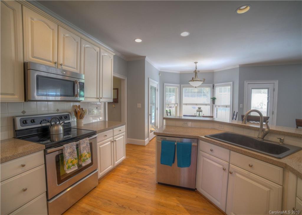 929 Ashford Way, Unit 79 Fort Mill, SC 29708 - Photo 9 of 39 a kitchen with kitchen island granite countertop a sink and stainless steel appliances
