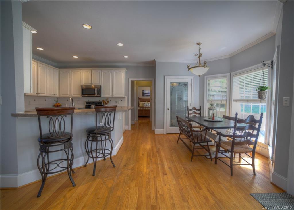 929 Ashford Way, Unit 79 Fort Mill, SC 29708 - Photo 10 of 39 a view of a dining room with furniture window and wooden floor