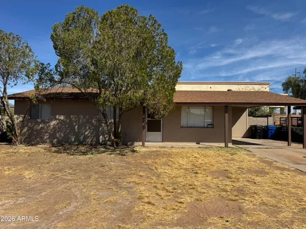 a view of garage with a small yard