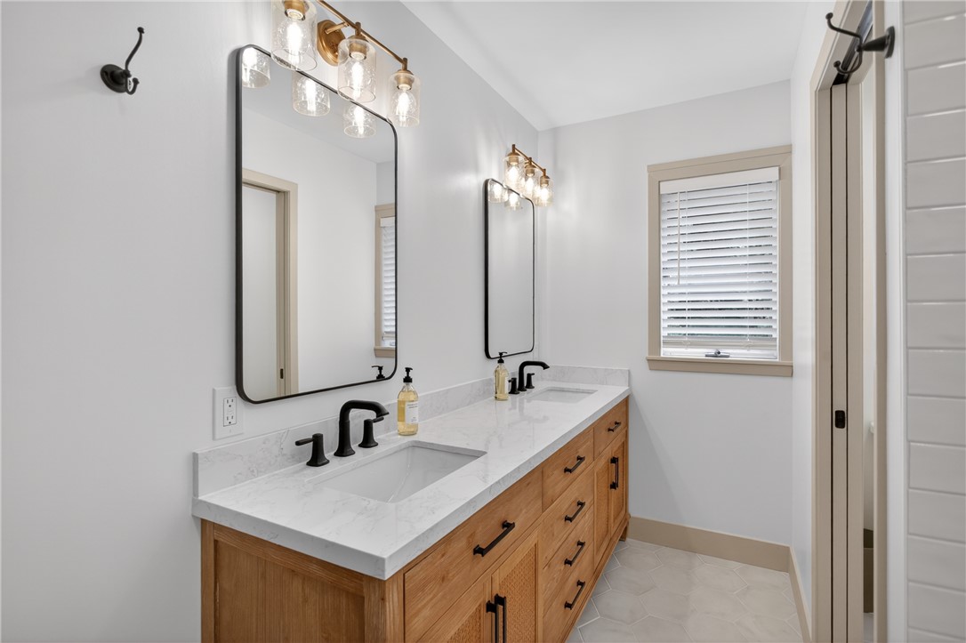304 Lakeside Drive Seneca, SC 29672 - Photo 25 of 50 Double vanities with sleek black fixtures elevate this pristine, well-lit bathroom.