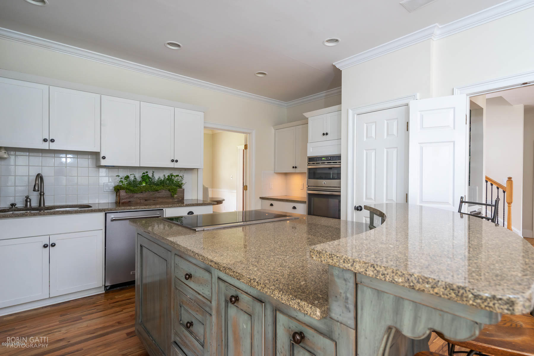 6150 Old Forsyth Road Macon, GA 31210 - Photo 34 of 50 a kitchen with granite countertop a sink a stove and cabinets