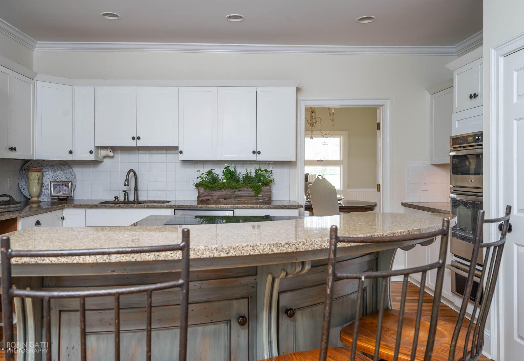 6150 Old Forsyth Road Macon, GA 31210 - Photo 35 of 50 a kitchen with a stove a sink and white cabinets