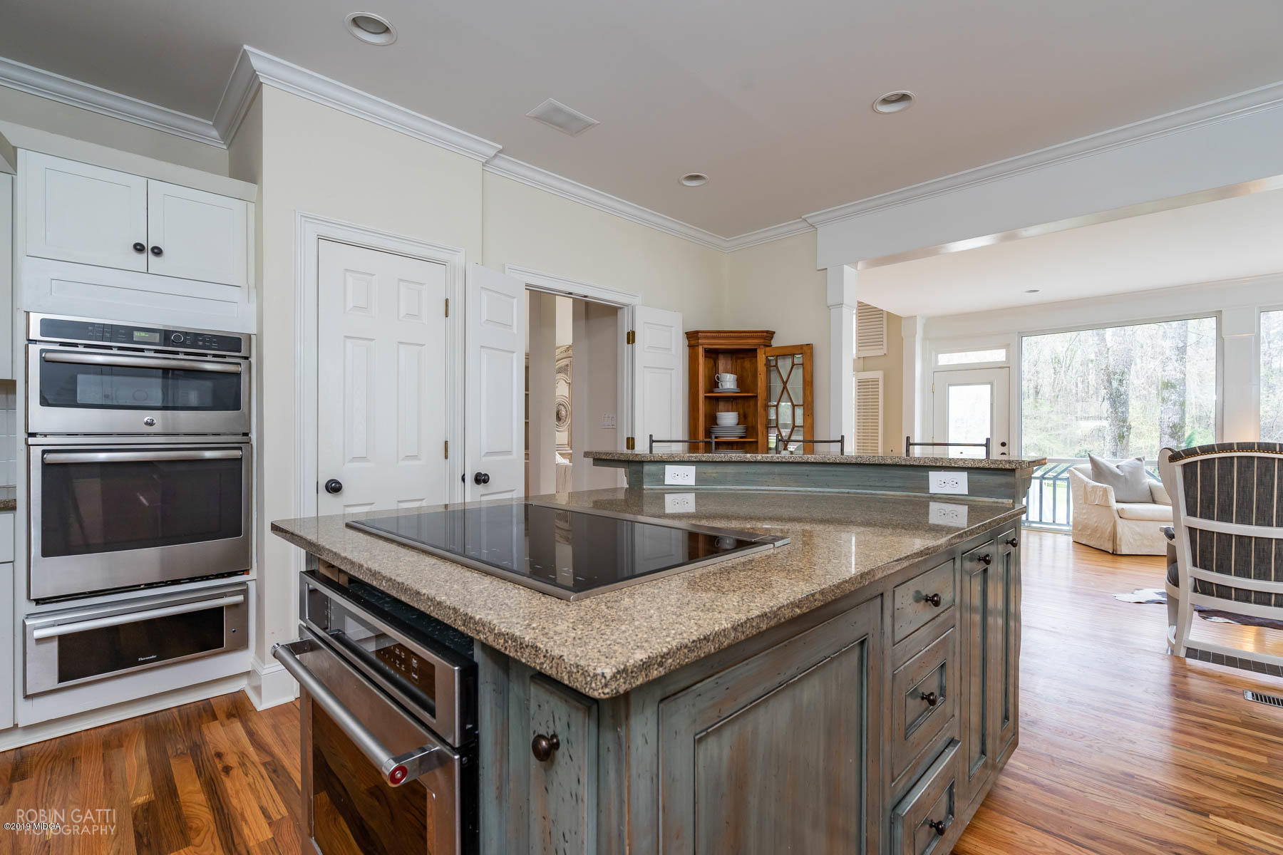 6150 Old Forsyth Road Macon, GA 31210 - Photo 37 of 50 a kitchen with granite countertop a sink and dishwasher a stove with wooden floor