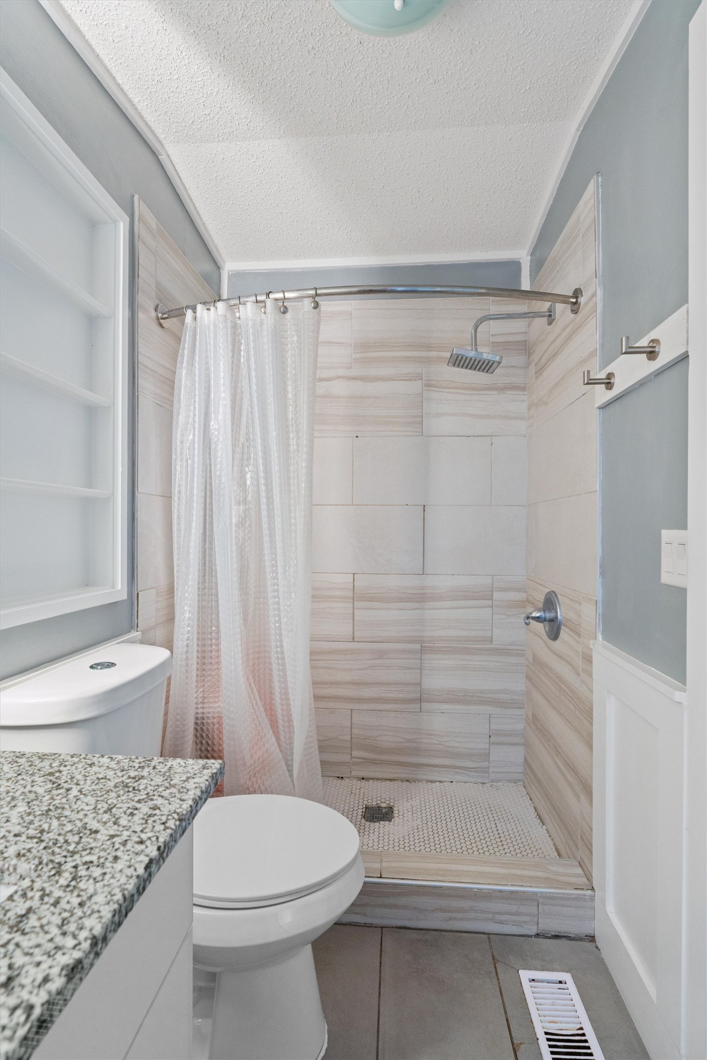 218 Boxcar Path Kyle, TX 78640 - Photo 8 of 21 A well-appointed bathroom features a spacious shower with contemporary tile work and a sleek overhead fixture.