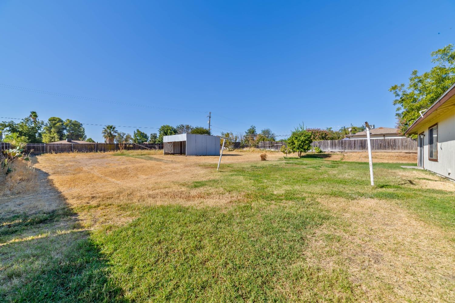 25612 Walden Avenue Madera, CA 93638 - Photo 15 of 33 a view of a field with an trees in the background