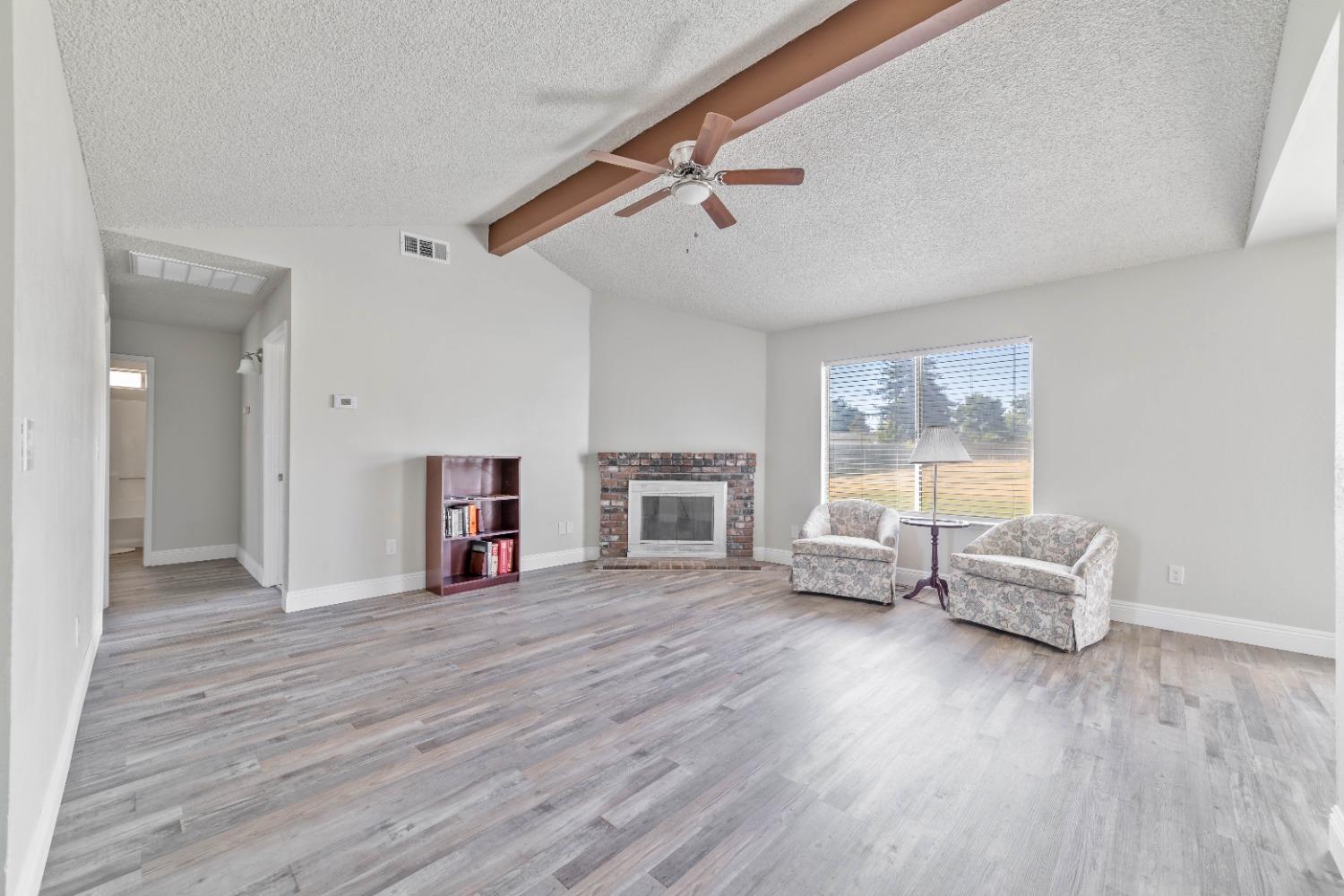 25612 Walden Avenue Madera, CA 93638 - Photo 16 of 33 a living room with furniture and a wooden floor