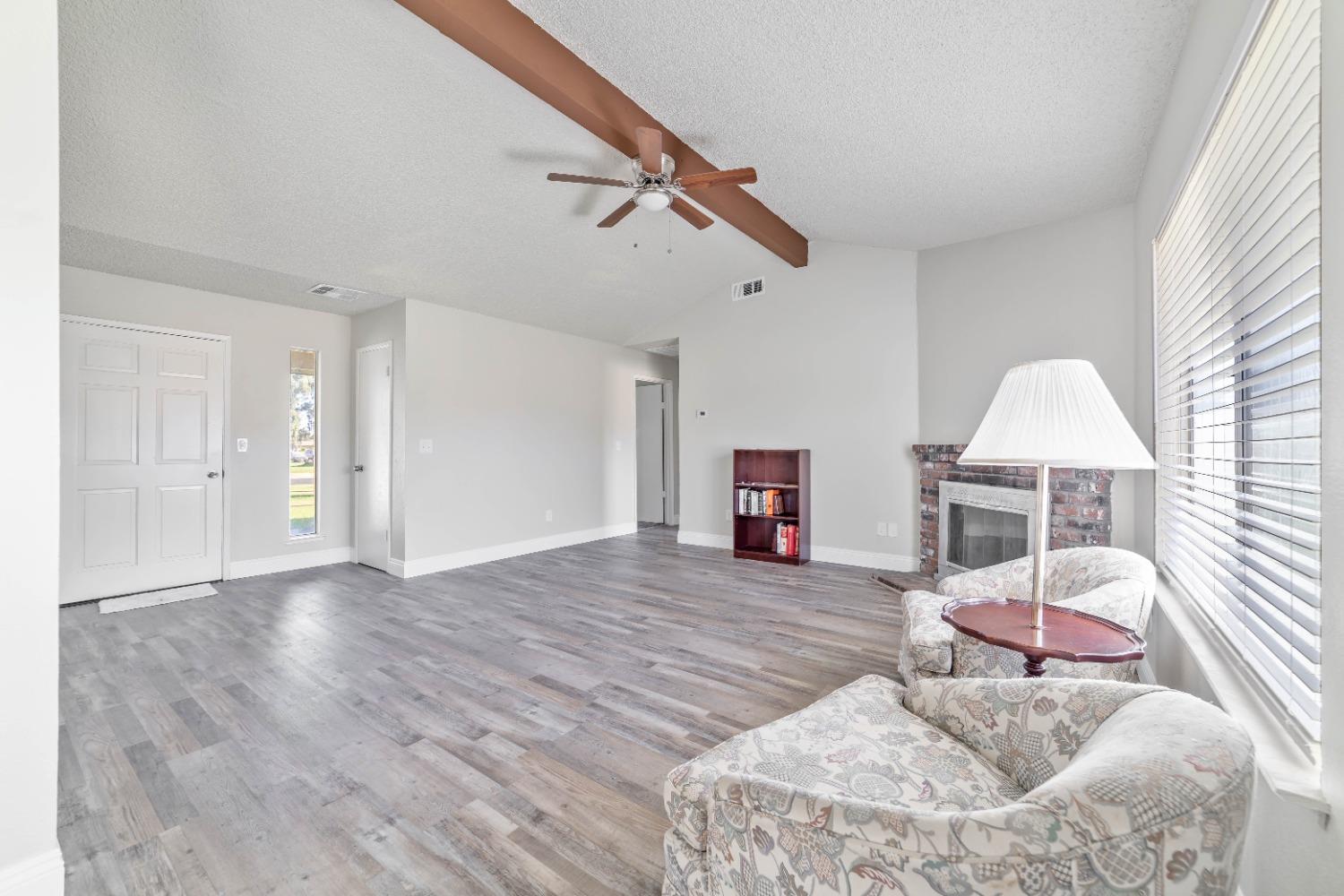 25612 Walden Avenue Madera, CA 93638 - Photo 18 of 33 a living room with furniture and a fireplace
