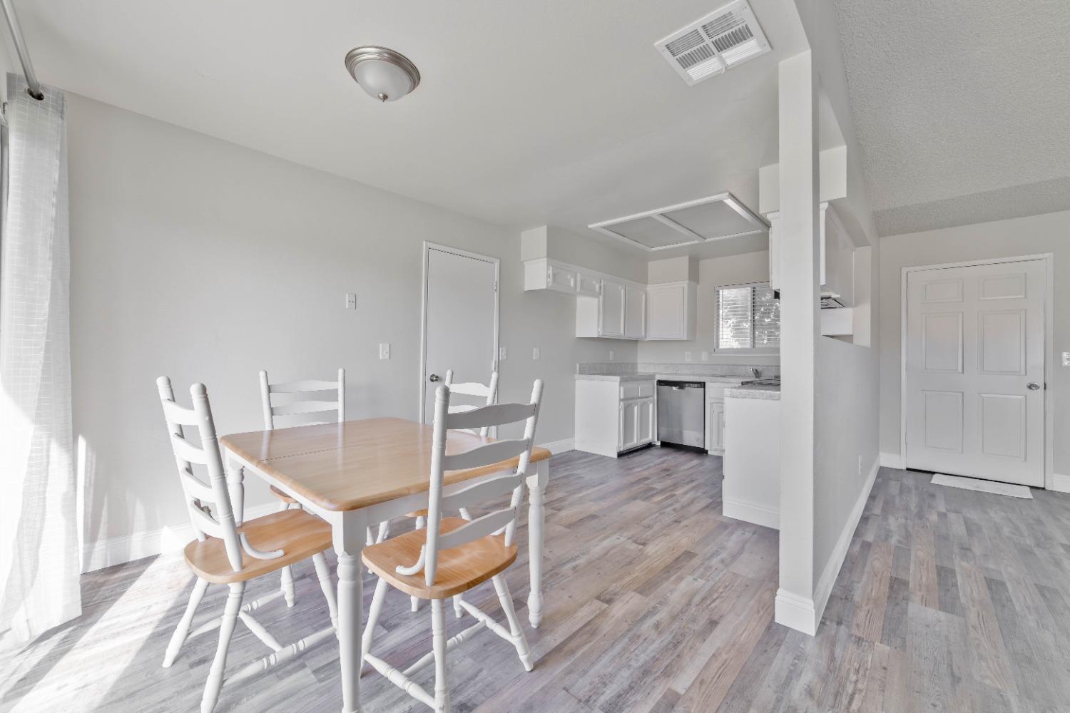 25612 Walden Avenue Madera, CA 93638 - Photo 20 of 33 a view of a dining room with furniture and wooden floor