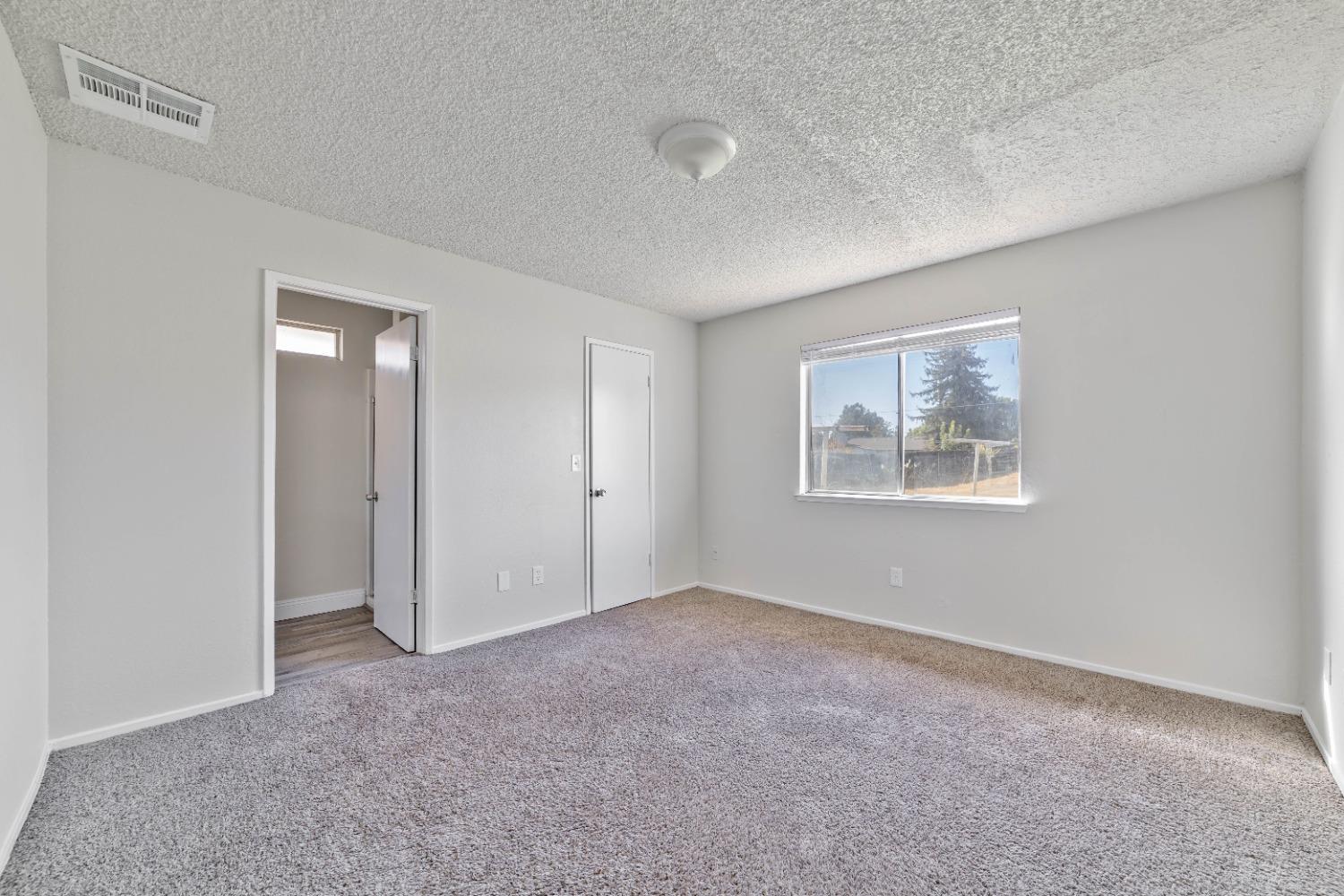 25612 Walden Avenue Madera, CA 93638 - Photo 22 of 33 a view of an empty room with a window