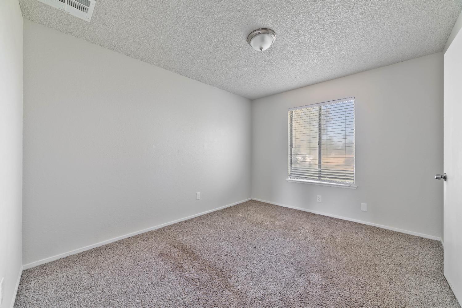 25612 Walden Avenue Madera, CA 93638 - Photo 29 of 33 an empty room with windows