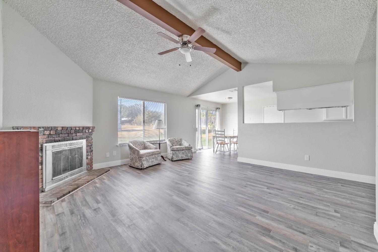 25612 Walden Avenue Madera, CA 93638 - Photo 8 of 33 a living room with furniture and a fireplace