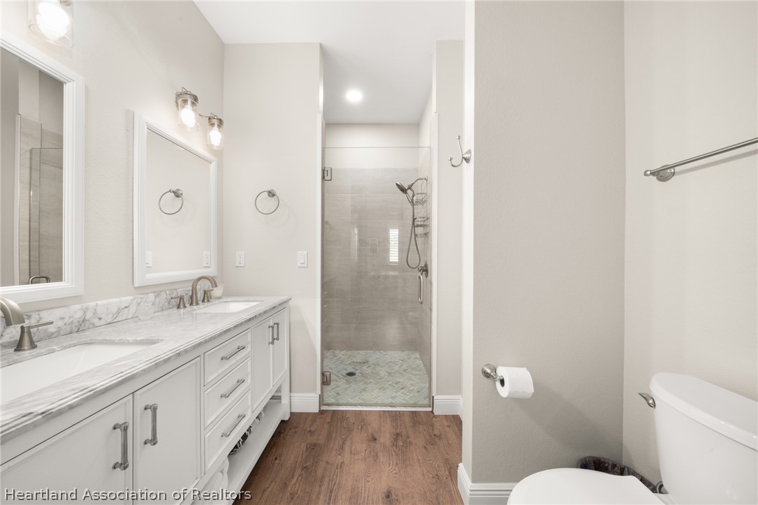 4734 Haw Branch Road, Unit 110 Sebring, FL 33875 - Photo 23 of 50 a bathroom with a double vanity sink toilet and shower