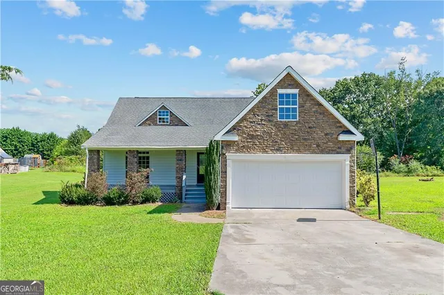 a front view of house with yard and green space
