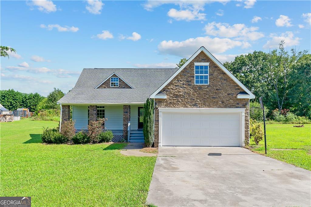 a front view of house with yard and green space