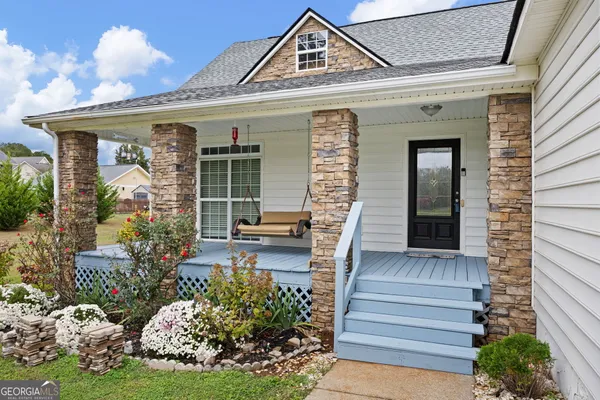 a front view of a house with garden