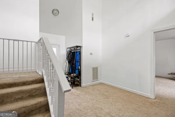 a view of a livingroom with a hall and stairs