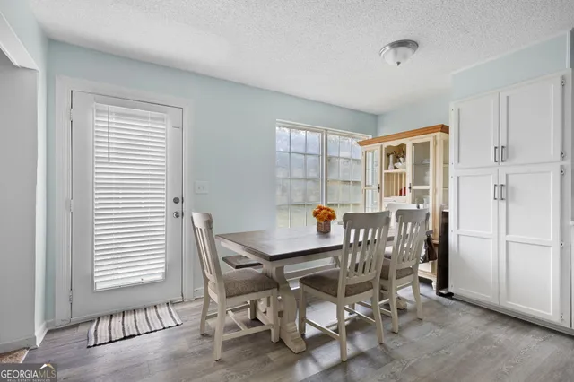 a dining room with furniture and window