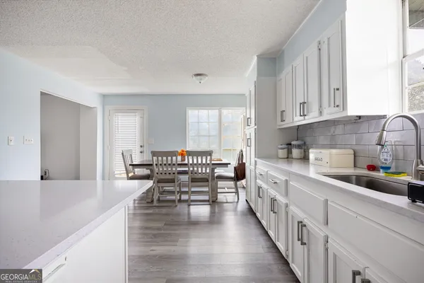 a kitchen with a sink stove and refrigerator