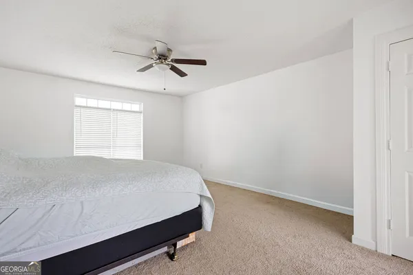 a bathroom with a toilet a sink and a window