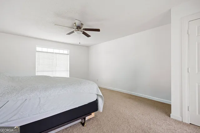 a bathroom with a toilet a sink and a window