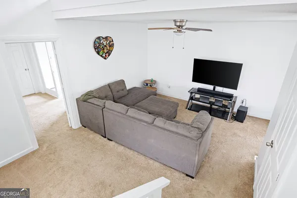 a room with a bed a chair and a chandelier