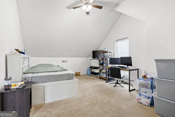 a view of a bedroom with closet and windows