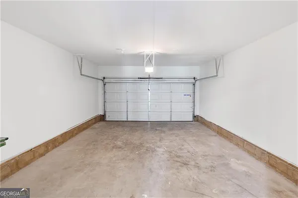 an empty room with chandelier fan